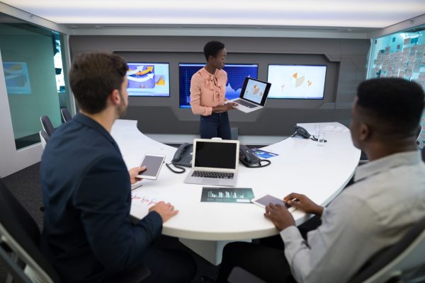 Male and female executives discussing over graph in boardroom enterprise seo