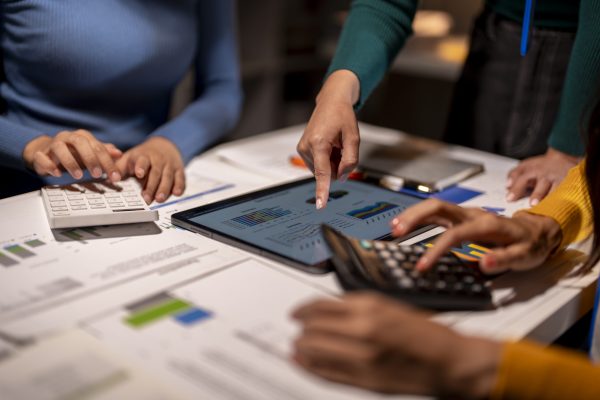 Three people are working on a project finance