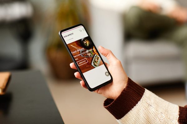 Woman ordering food online on phone software